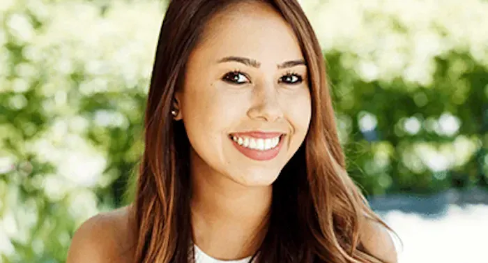 A headshot of a woman with brown hair smiling.