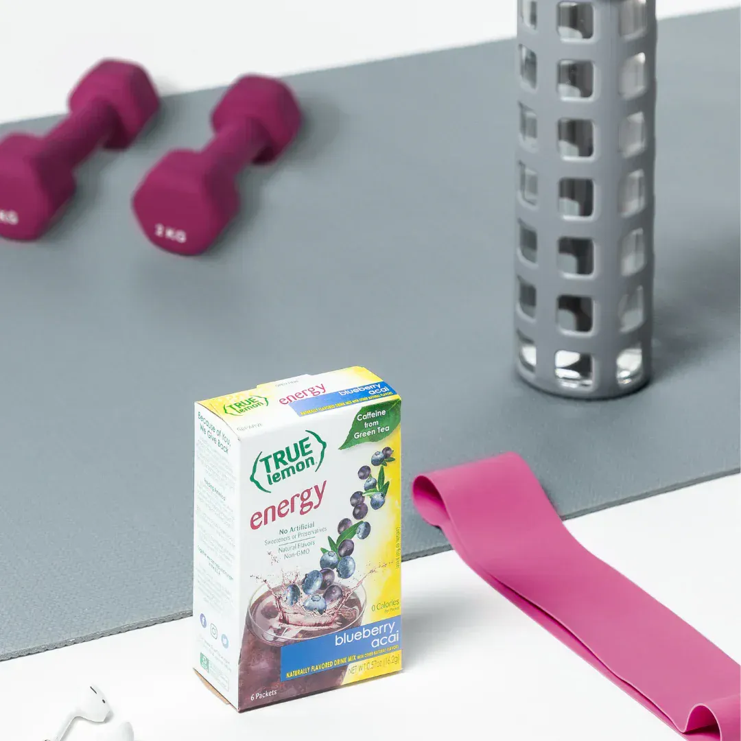 A box of True Lemon energy among workout equipment.