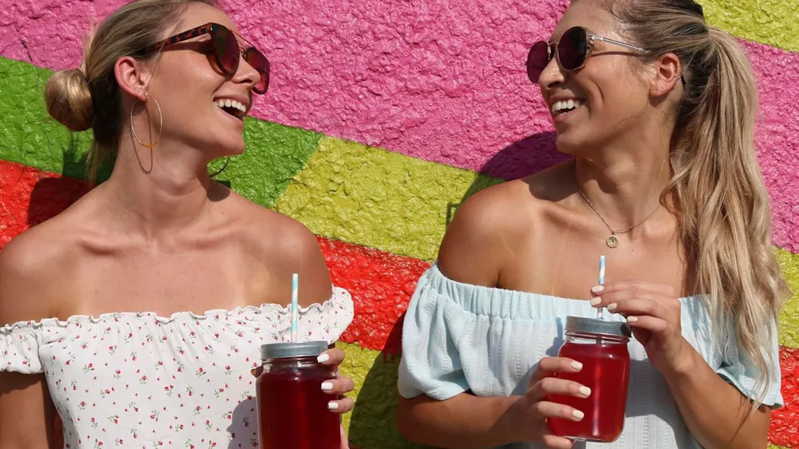 Women drinking low-sugar energy drinks outdoors