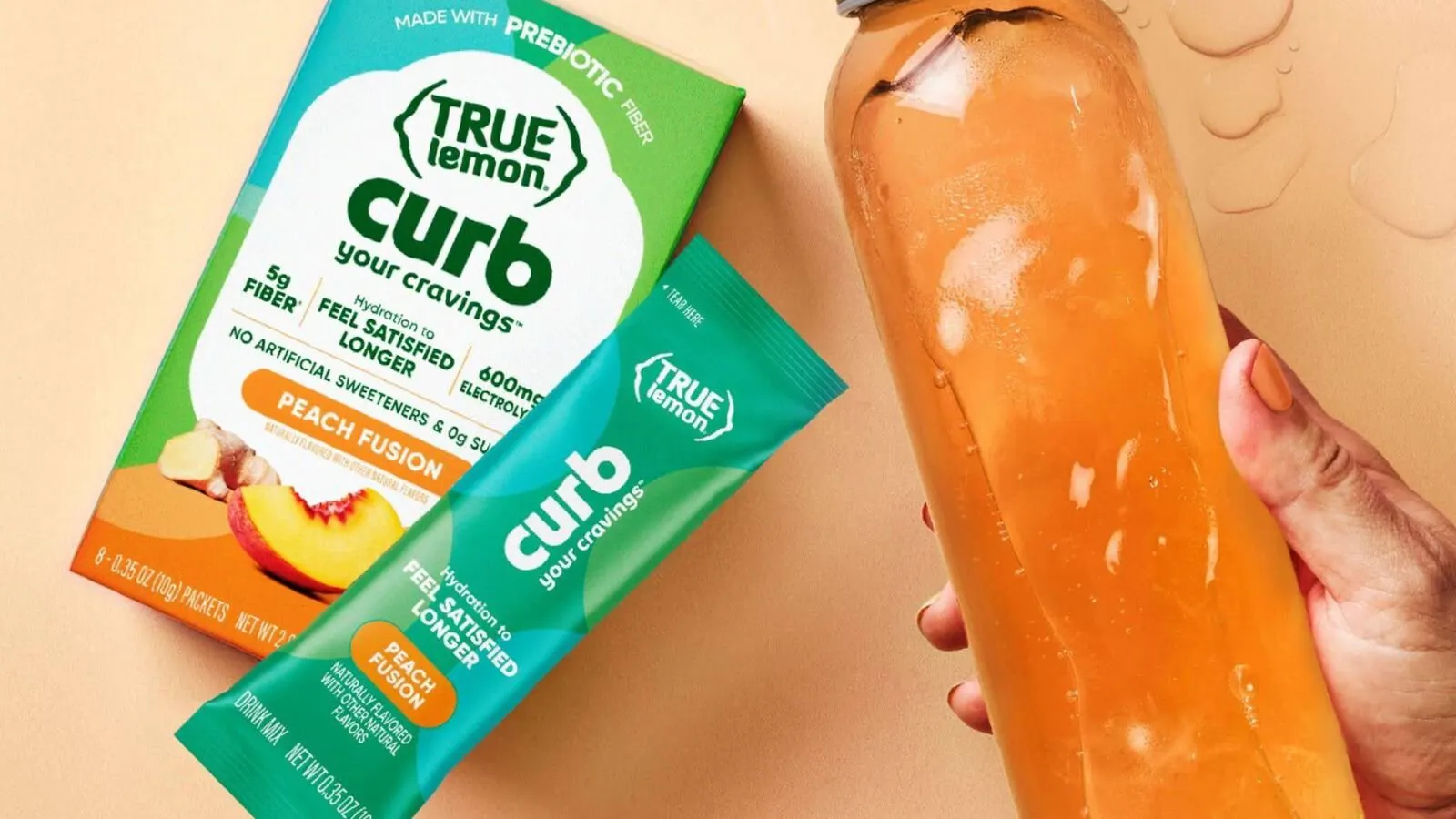 Hand Holding A Bottle Of Water Mixed With True Lemon Curb Peach Fusion