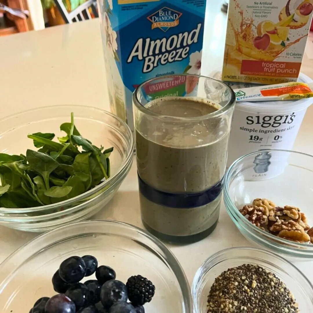 Smoothie with spinach, almond milk, True Lemon Energy, walnuts, chia seeds and blueberries