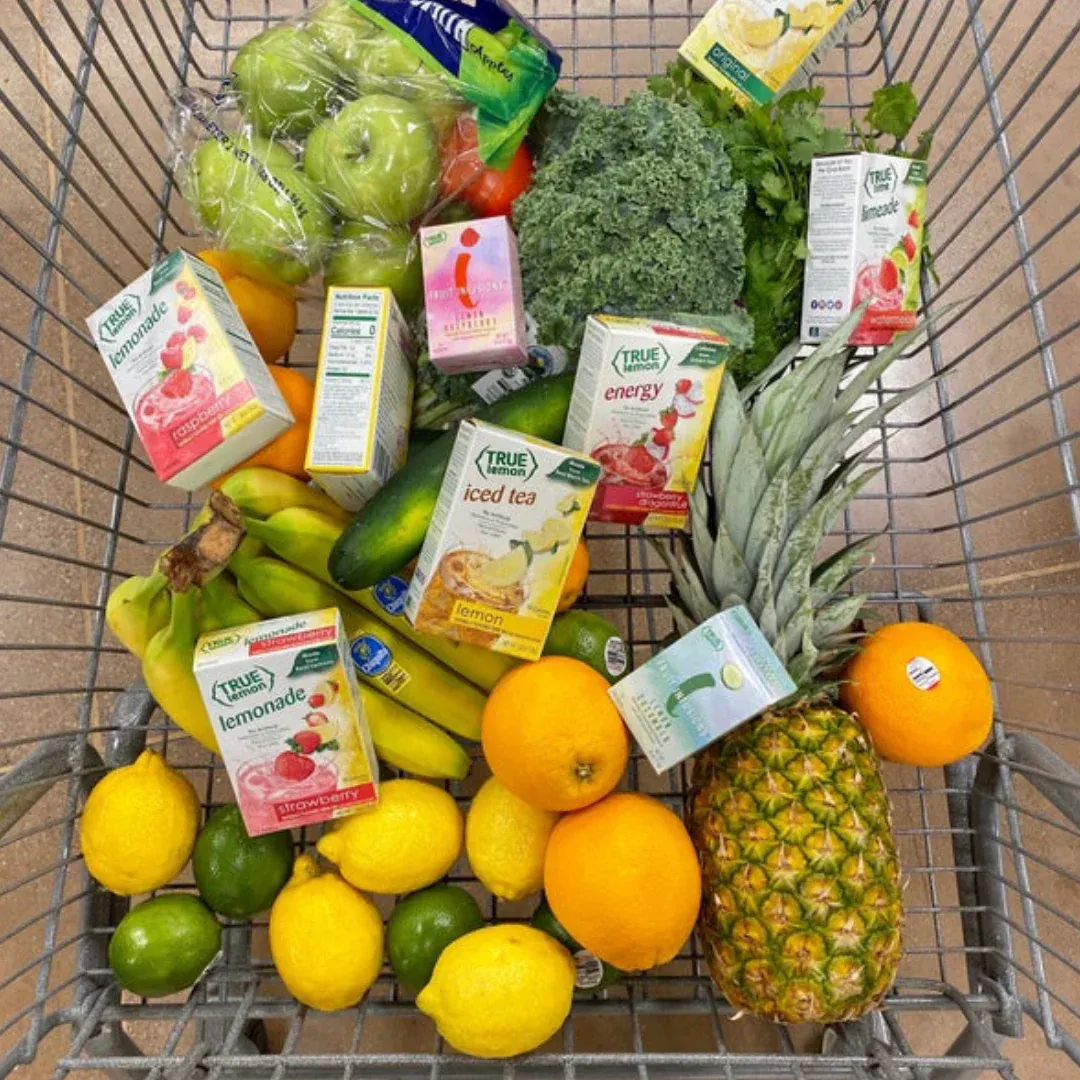A cart full fruits, veggies, and True Citrus products.