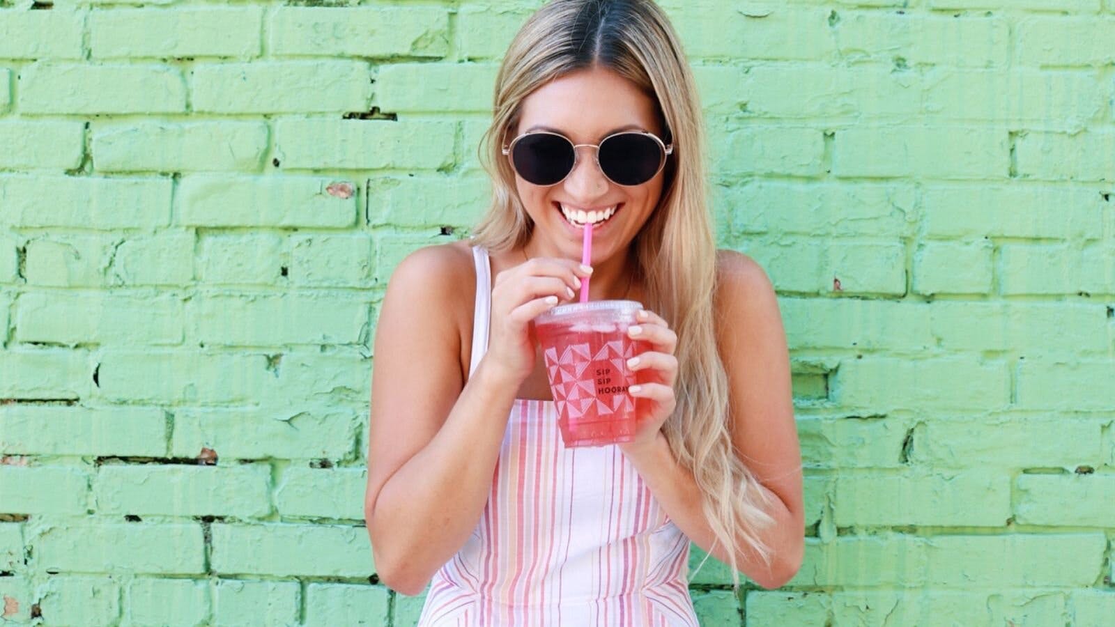 Woman Happily Drinking True Lemon Energy With Green Tea Caffeine