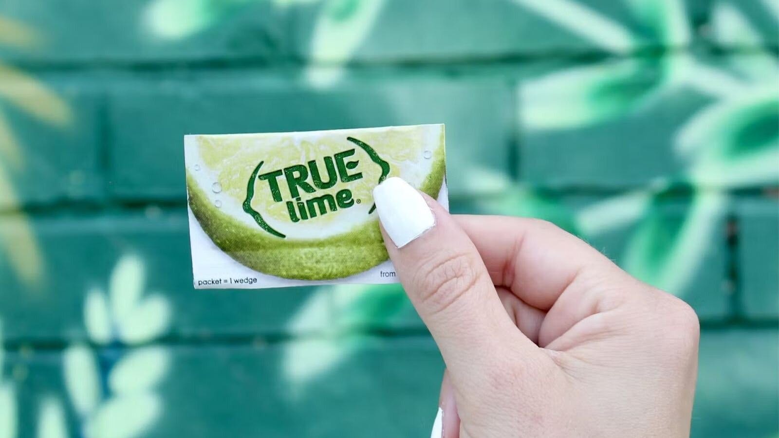 Person Holding A Crystallized Lime Packet