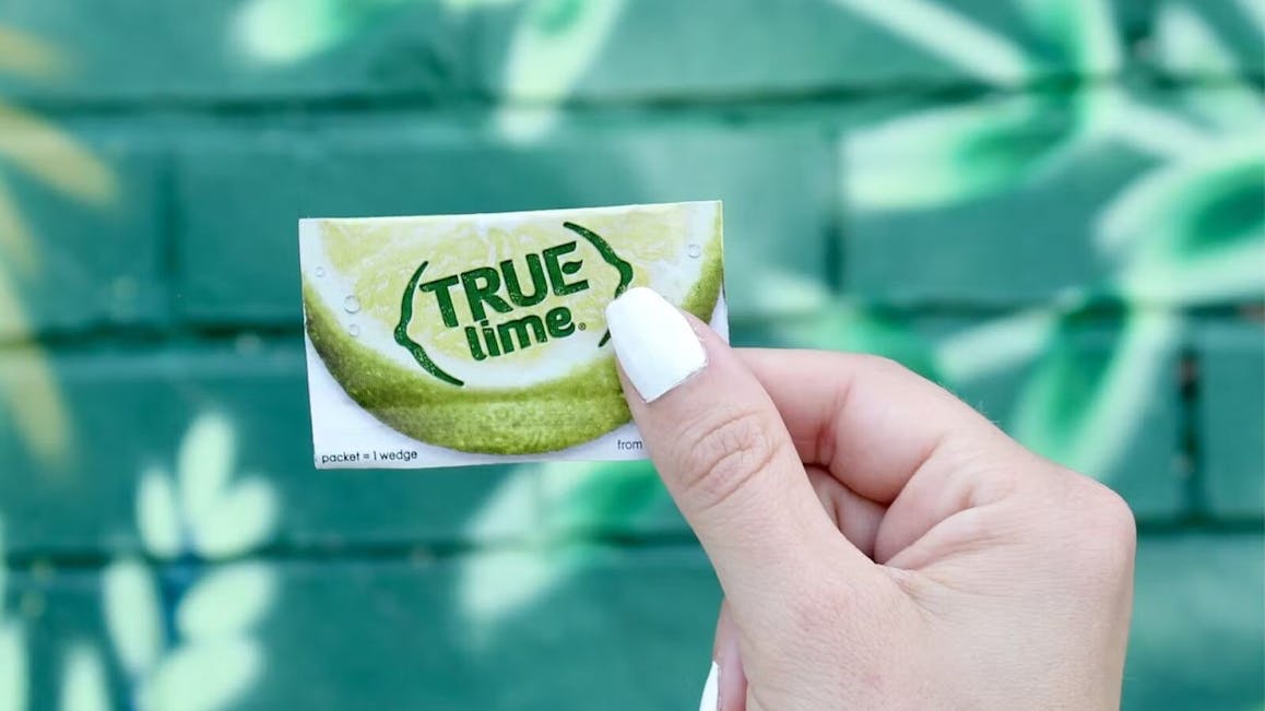Person Holding A Crystallized Lime Packet